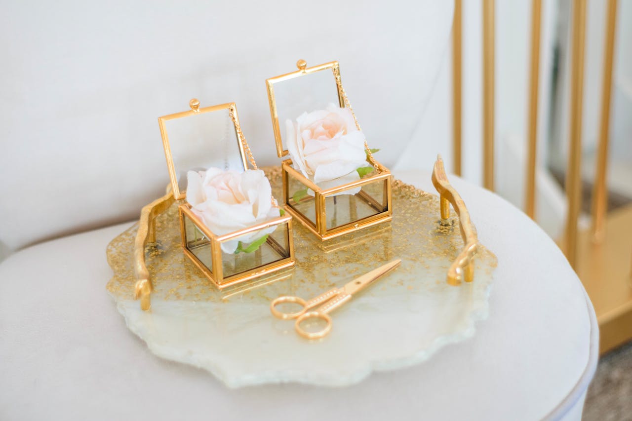 Crafting Captivating Headlines: Your awesome post title goes here Two gold glass boxes with roses on a tray, ideal for wedding decor photography.