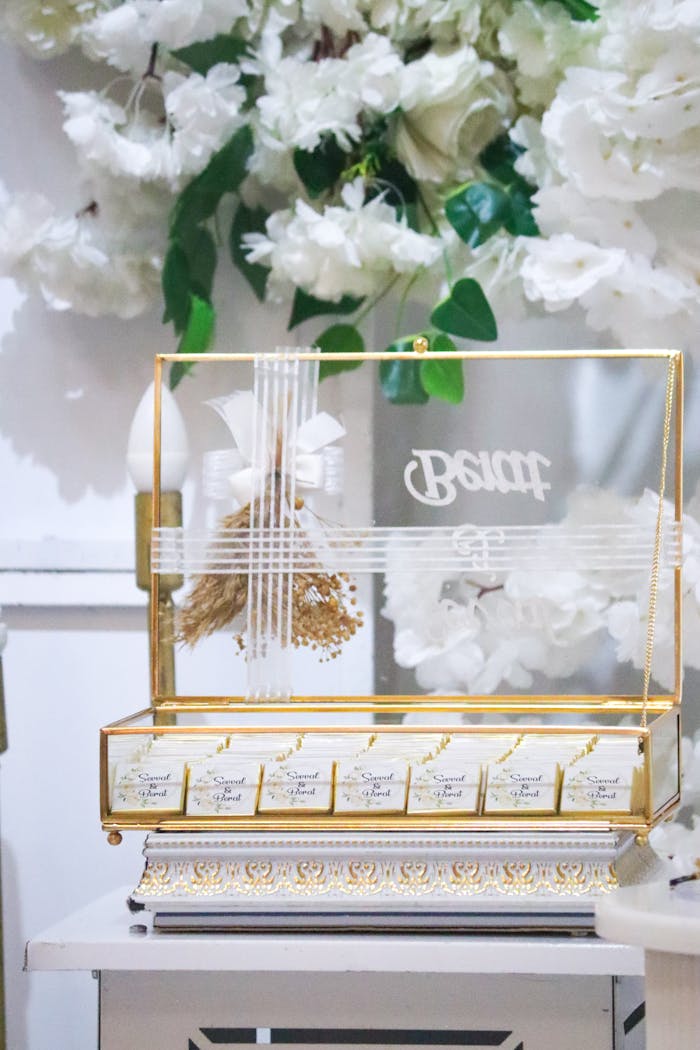 Home A sophisticated floral arrangement with gold-trimmed box, perfect for weddings.