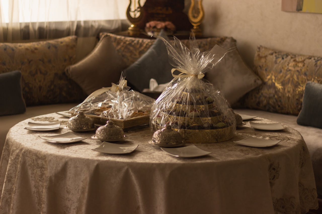 Cozy room with a table featuring gift-wrapped treats and elegant tableware.